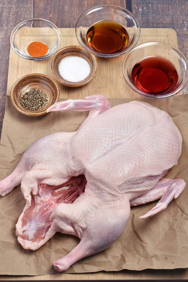 Ingredients for roast duck with maple glaze arranged on a cutting board. 
